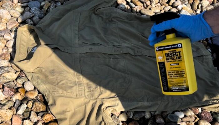  Spraying-on-clothes-with-permethrin-spray
