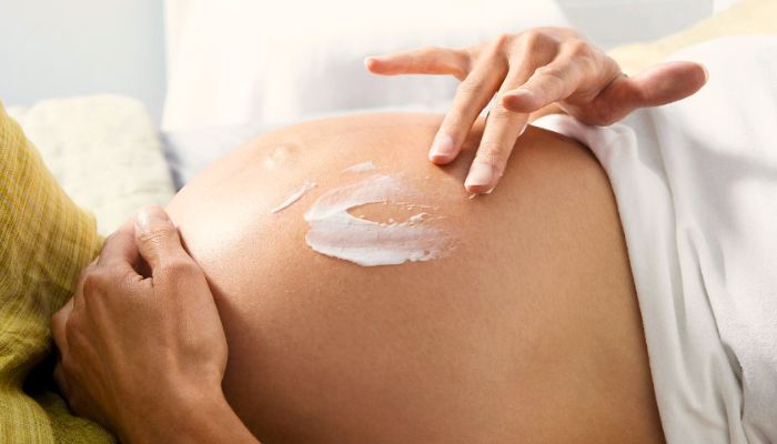  putting-cream-on-pregnant-belly.