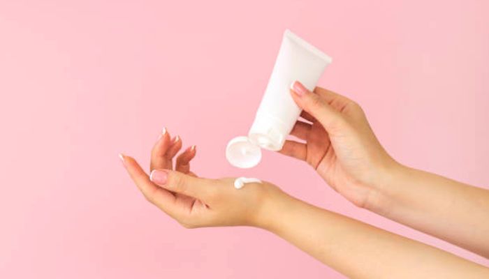  woman-applying-cream-to-hands-and-arms.